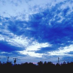 Low angle view of power lines against sky