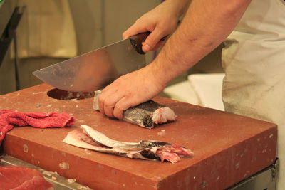 Close-up of man preparing food on cutting board