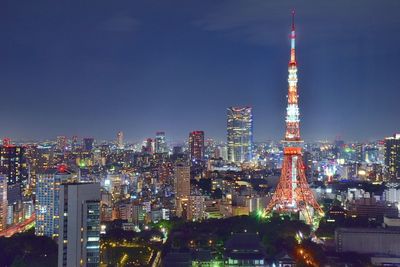 Illuminated cityscape against sky at night