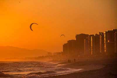 Silhouette of person at beach during sunset