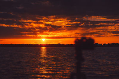 Scenic view of sea against orange sky