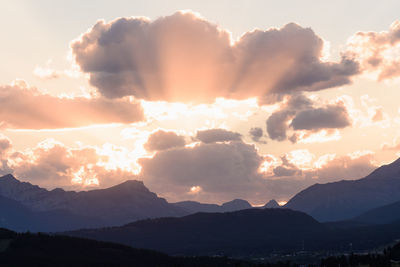 Scenic view of silhouette mountains against dramatic sky