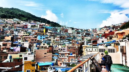 High angle view of cityscape against cloudy sky