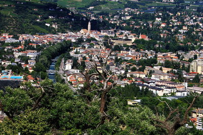 High angle view of townscape against trees in city
