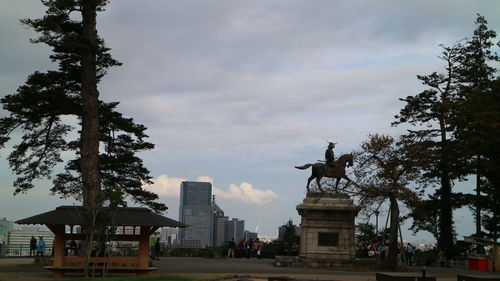 Statue against sky in city