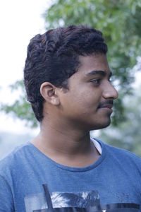 Young man against tree