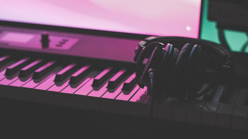 Close-up of a keyboard and headphones in a studio