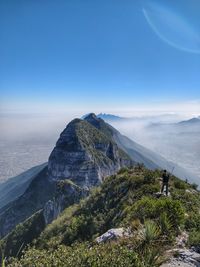 Scenic view of mountains against blue sky