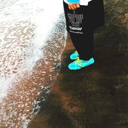 Low section of woman standing on tiled floor