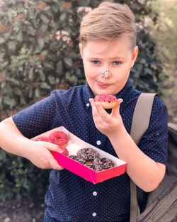 Portrait of boy eating food