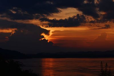 Scenic view of sea against orange sky