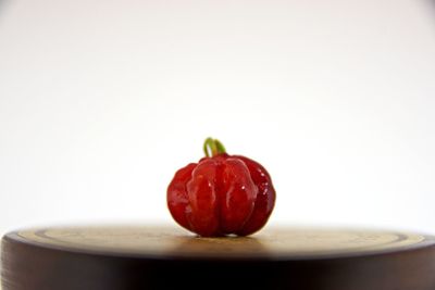 Close-up of apple on table against white background