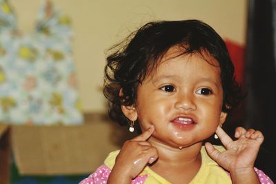 Close-up of innocent girl at home