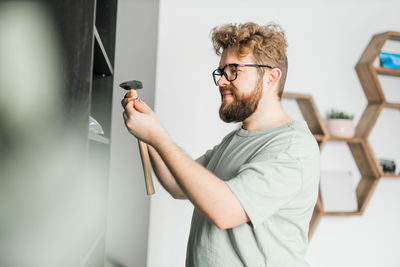 Side view of man using mobile phone