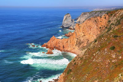 Scenic view of sea and rock formation against sky