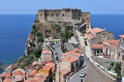 High angle view of townscape by sea against sky