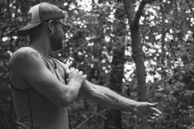 Young man showing off tattoo on arm