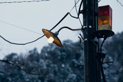 Low angle view of street light against sky