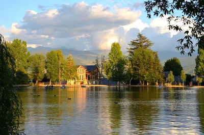 Scenic view of lake by building against sky