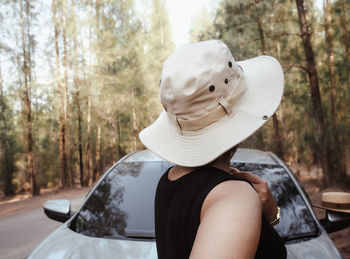 Portrait of man wearing hat against trees in forest