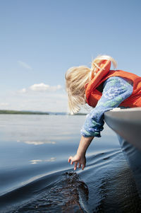 Girl looking at sea from boat