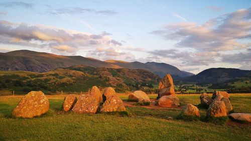 Scenic view of stone circle and mountains against sky