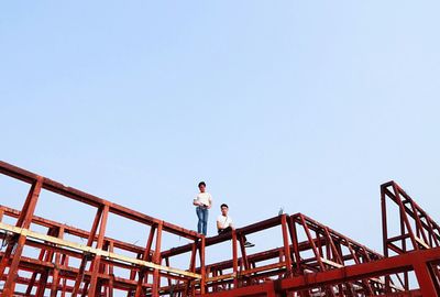 Low angle view of woman against clear sky