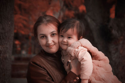 Portrait of mother and daughter outdoors