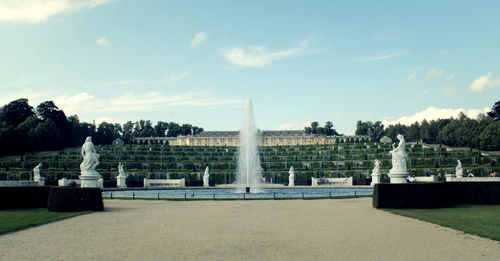 Fountain in park against sky