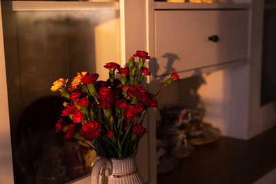 Close-up of red rose flower vase at home