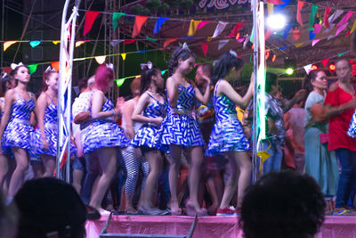 Group of people dancing on stage at night