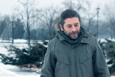 Portrait of man standing in snow