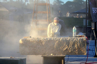 Artist making stone sculpture