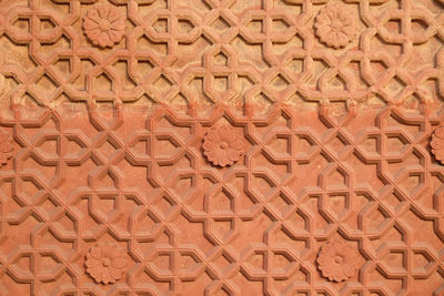 Stone pattern on a temple wall in red fort, agra, unesco world heritage site, india