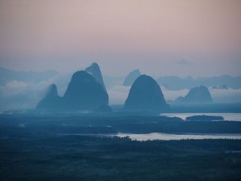 Scenic view of sea and mountains against sky