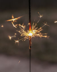 Close-up of sparkler at night