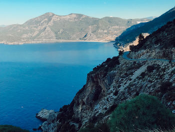 Scenic view of sea and mountains against sky