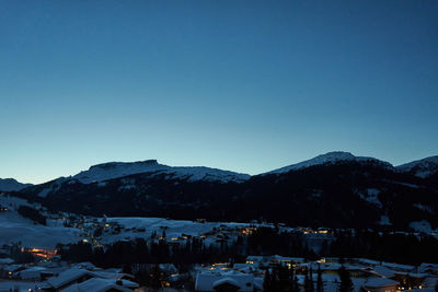 Scenic view of snowcapped mountains against clear blue sky