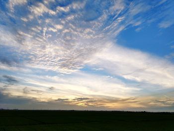 Scenic view of field against sky during sunset