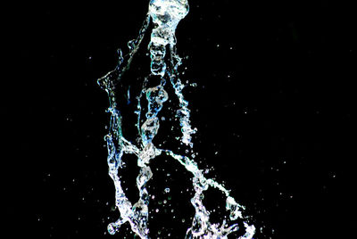 Close-up of water splashing against black background