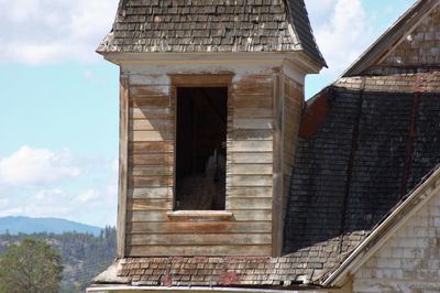 Low angle view of building against cloudy sky