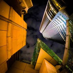 Low angle view of illuminated modern building at night