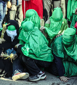 Men in green costume on street during carnival