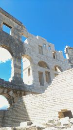 Low angle view of historical building against blue sky