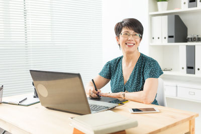 Woman using phone on table