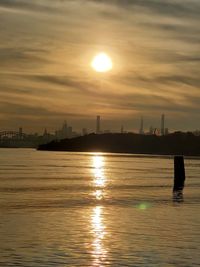 Scenic view of silhouette city against sky during sunset