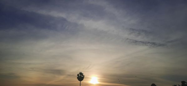 Low angle view of silhouette man against sky during sunset