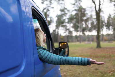 Side view of woman in car