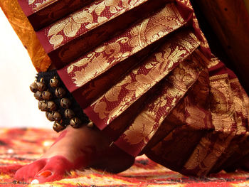 Close-up of woman reading book on bed