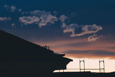 Low angle view of silhouette building against sky